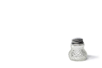 Jars of salt and pepper on a white background