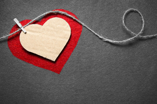 Black white red. Valentine's day. Heart from cardboard on rope with clothespin on black and white background with the gradient effect.