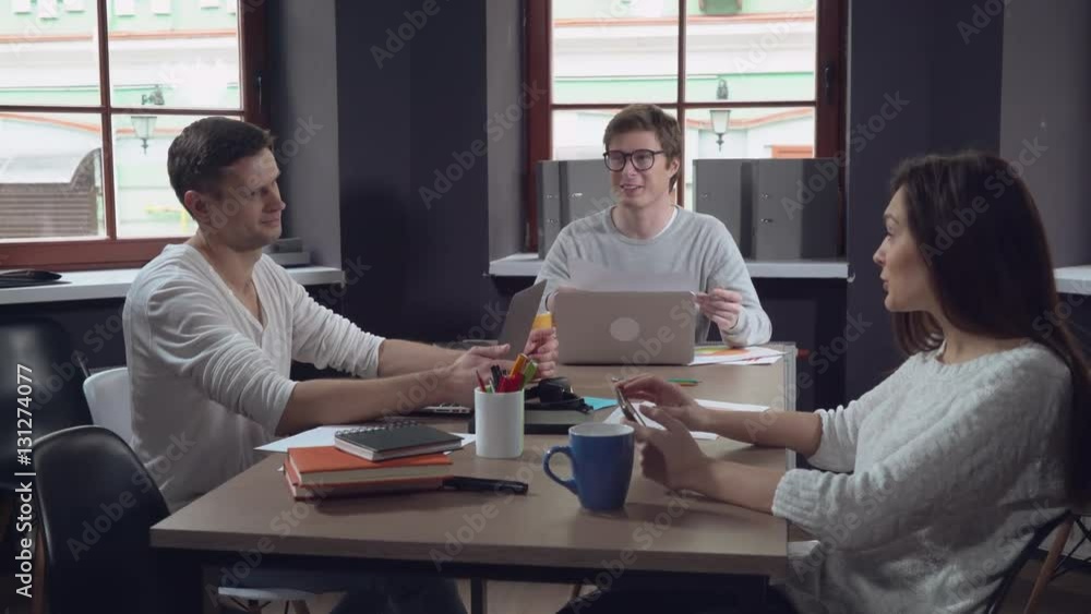 Aufkleber happy professional group of people sitting at the working place in contemporary office. young smilin