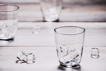 Empty drinking glass with ice on wood boards