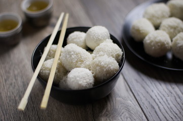 Homemade chinese Tang Yuan dumplings with coconut sprinkles in b