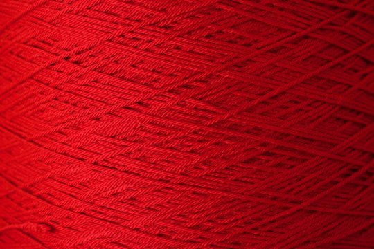 Red Crochet Yarn Threads close-up shot background texture