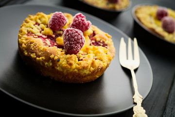 Sweet delicious homebaked raspberry jam crumble tart with frozen