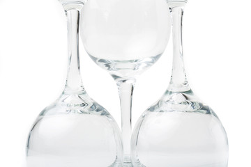 Wine glasses arranged on a table, isolated over white