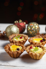 Homemade desserts with fruits for the new year. Desserts for the holidays. Side view. Against dereeva and trees. Beautiful background.