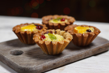 Homemade desserts with fruits for the new year. Desserts for the holidays. Side view. Against dereeva and trees. Beautiful background.