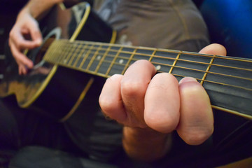 Obraz premium Close Up Of Guitarist Playing Acoustic Guitar