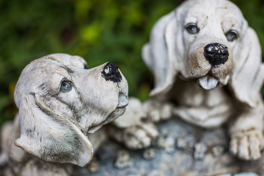 Heads of white porcelain puppies