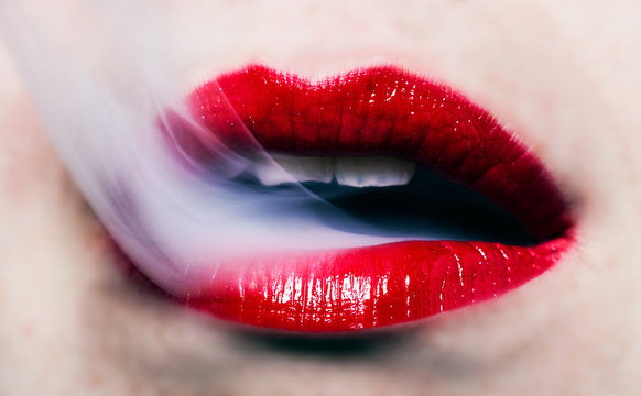 Head on view of a woman with vapor escaping her lips