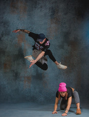 The two young girl and boy dancing hip hop in the studio