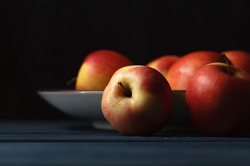 Fresh red apples on wooden blue background