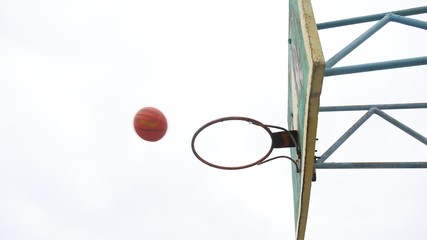 Fototapeta na wymiar sport old hoop basketball bottom view outdoors rusty iron ball enters the basket