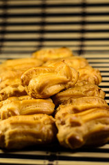 Rows of eclairs on a bamboo mat. Selective focus