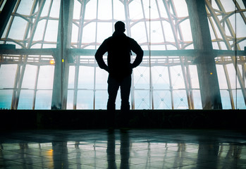 Obraz na płótnie Canvas Silhouette of man standing over window