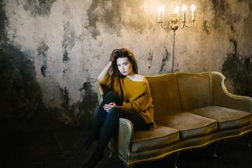 beautiful girl sitting on a luxury sofa