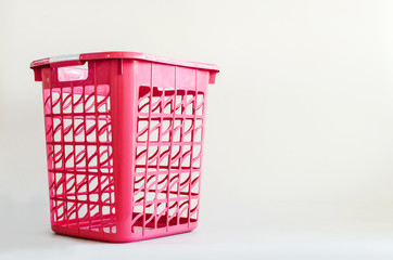 Pink plastic basket on white background