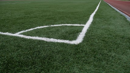 Fototapeta na wymiar football Soccer field corner with green artificial sport grass
