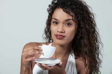 Young woman drinks a coffee