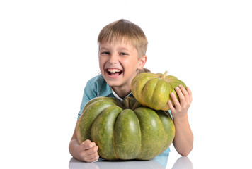 Fototapeta premium Cute boy sitting with different pumpkins