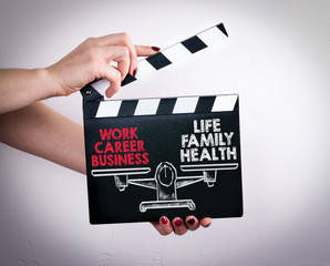 Work Life Balance. Female hands holding movie clapper. 