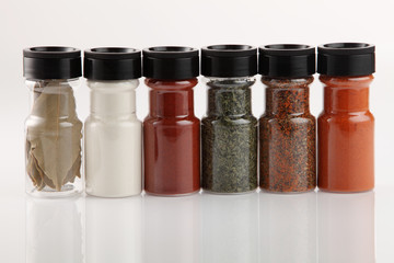 Various spices in small glass bottles, close up