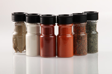 Various spices in small glass bottles, close up