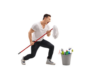 Young man singing on a mop