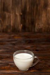 Cup of milk on rustic wooden table
