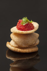 Red caviar on chicken chips