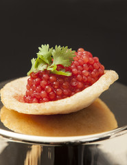 Red caviar on chicken chips