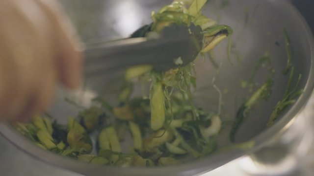 Chef is prepare seaweed salad with seafood, slow motion