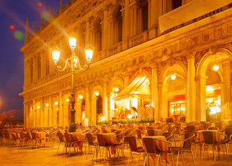 Square San Marco and street cafe tables at night, Venice, Italy