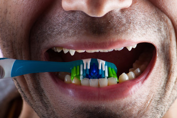 New tooth brush on the background of the person. 