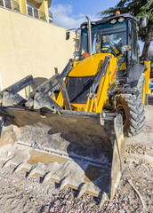 Break. Yellow excavator with shovel at construction site