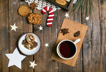 New Year's day breakfast tea with nuts and sugar cane on wooden background