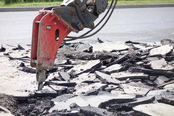 Street roadway reconstruction. Breaker divide old asphalt.