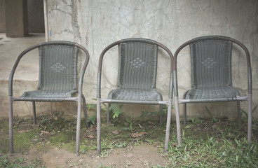 Fototapeta na wymiar Three retro chair against a white wall.