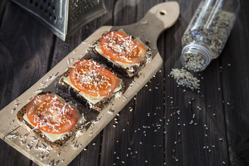 Healthy sandwiches with tomatoes, cheese, sesame and linseed