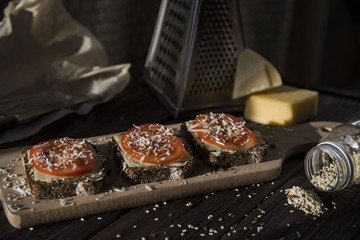 Healthy sandwiches with tomatoes, cheese, sesame and linseed