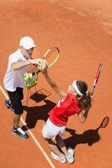 Practicing tennis service