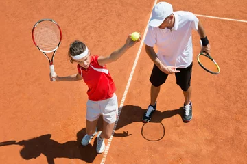 Zelfklevend Fotobehang Practicing tennis service © Microgen
