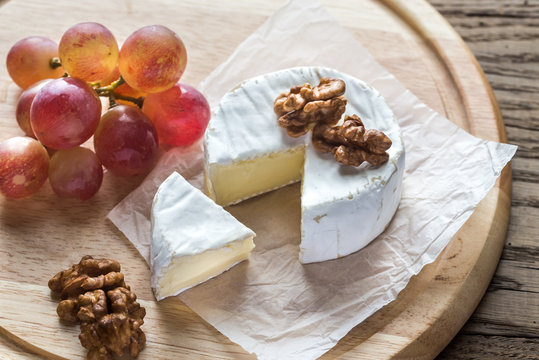 Camembert cheese with walnuts and grape