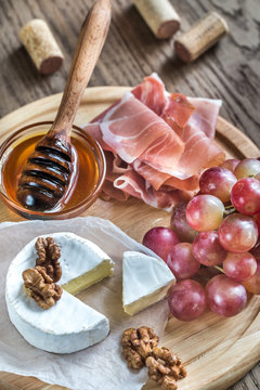 Camembert cheese with nuts and prosciutto
