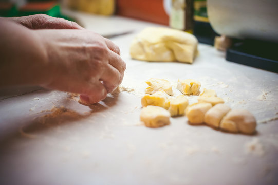 hand modeling dumplings at home in the kitchen. hands and the dough