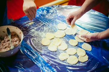 Foto op Canvas hand modeling dumplings at home in the kitchen. © evgeniykleymenov
