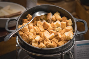 Bread baked in a black bowl and spoon