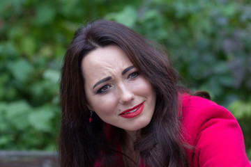 Portrait of expressive woman in a red coat. People