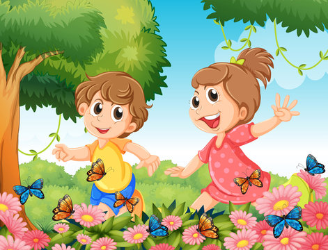 Boy and girl playing with butterflies in garden