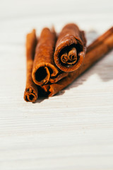 several fragrant cinnamon sticks on a white background