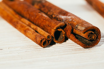 several fragrant cinnamon sticks on a white background